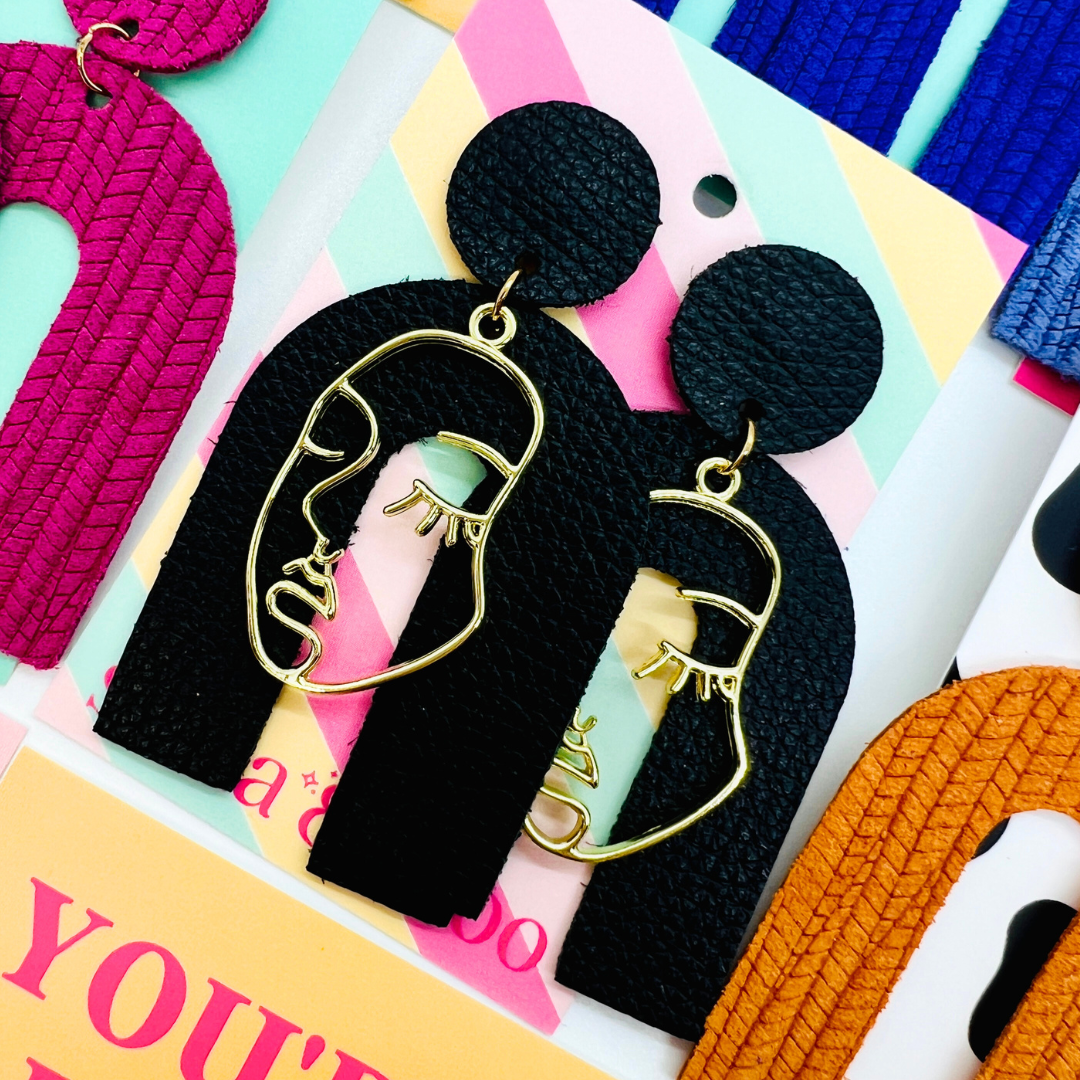 Bold statement earrings in vibrant colors, lightweight and comfortable for all-day wear, handcrafted sustainable leather earrings, eco-friendly jewelry with modern designs, festive holiday earrings perfect for gifting, celestial sun and moon motifs, boho styles with earthy tones, playful Dalmatian print earrings, minimalist earrings styled for the season, bold designs from a small, women-owned business, gift-worthy feather-light earrings, sustainable and recycled leather for eco-conscious fashion