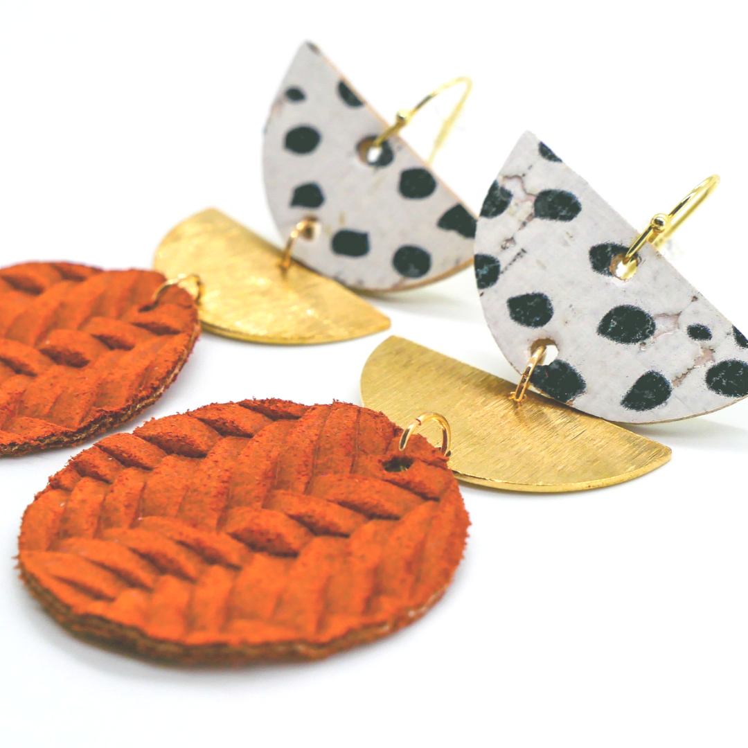 Bold statement earrings in vibrant colors, lightweight and comfortable for all-day wear, handcrafted sustainable leather earrings, eco-friendly jewelry with modern designs, festive holiday earrings perfect for gifting, celestial sun and moon motifs, boho styles with earthy tones, playful Dalmatian print earrings, minimalist earrings styled for the season, bold designs from a small, women-owned business, gift-worthy feather-light earrings, sustainable and recycled leather for eco-conscious fashion