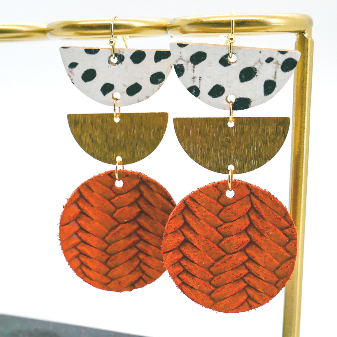Bold statement earrings in vibrant colors, lightweight and comfortable for all-day wear, handcrafted sustainable leather earrings, eco-friendly jewelry with modern designs, festive holiday earrings perfect for gifting, celestial sun and moon motifs, boho styles with earthy tones, playful Dalmatian print earrings, minimalist earrings styled for the season, bold designs from a small, women-owned business, gift-worthy feather-light earrings, sustainable and recycled leather for eco-conscious fashion