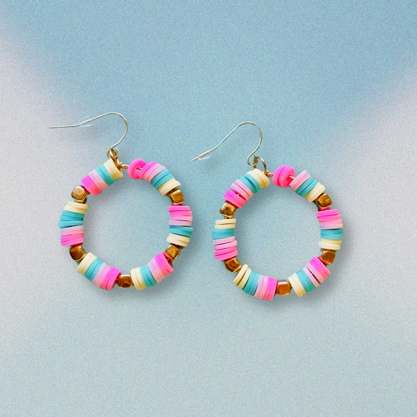 A pair of hot pink, pastel pink, teal, and yellow hoop earrings with gold accents, inspired by cotton candy, for a fun and whimsical jewelry statement.