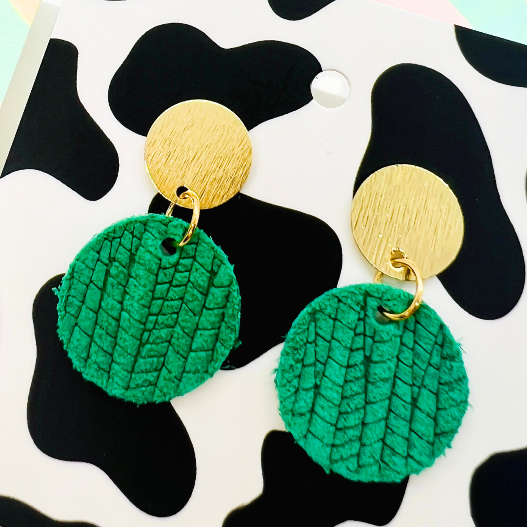 Bold statement earrings in vibrant colors, lightweight and comfortable for all-day wear, handcrafted sustainable leather earrings, eco-friendly jewelry with modern designs, festive holiday earrings perfect for gifting, celestial sun and moon motifs, boho styles with earthy tones, playful Dalmatian print earrings, minimalist earrings styled for the season, bold designs from a small, women-owned business, gift-worthy feather-light earrings, sustainable and recycled leather for eco-conscious fashion
