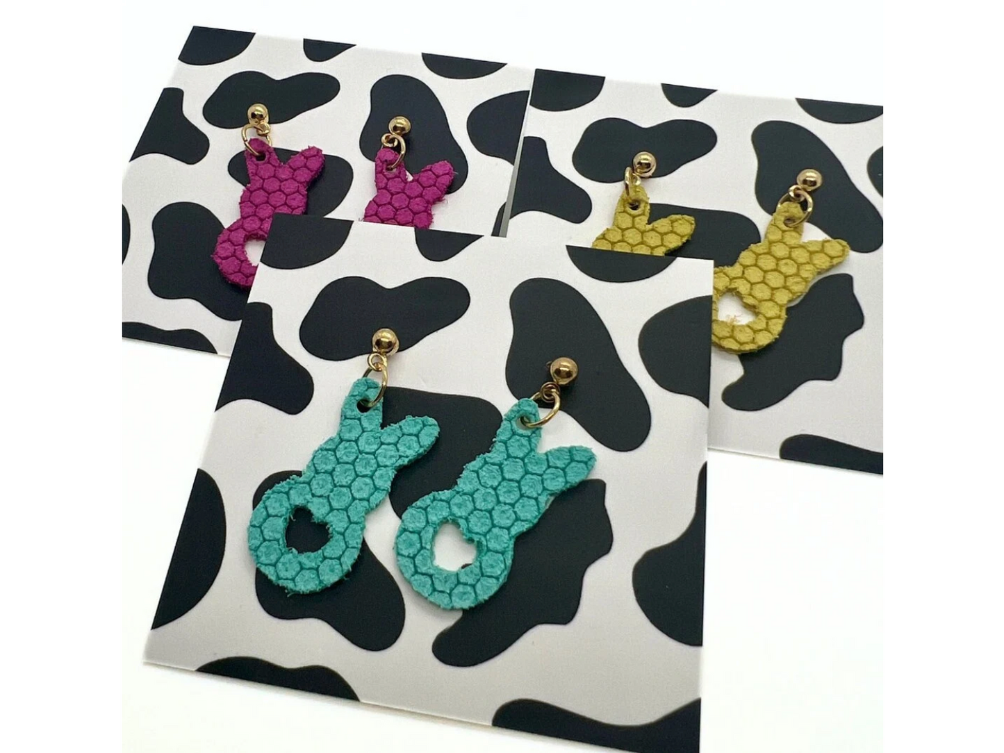 Bold statement earrings in vibrant colors, lightweight and comfortable for all-day wear, handcrafted sustainable leather earrings, eco-friendly jewelry with modern designs, festive holiday earrings perfect for gifting, celestial sun and moon motifs, boho styles with earthy tones, playful Dalmatian print earrings, minimalist earrings styled for the season, bold designs from a small, women-owned business, gift-worthy feather-light earrings, sustainable and recycled leather for eco-conscious fashion