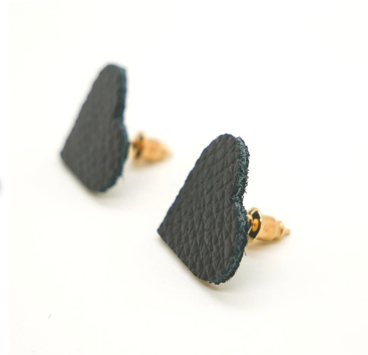 Bold statement earrings in vibrant colors, lightweight and comfortable for all-day wear, handcrafted sustainable leather earrings, eco-friendly jewelry with modern designs, festive holiday earrings perfect for gifting, celestial sun and moon motifs, boho styles with earthy tones, playful Dalmatian print earrings, minimalist earrings styled for the season, bold designs from a small, women-owned business, gift-worthy feather-light earrings, sustainable and recycled leather for eco-conscious fashion