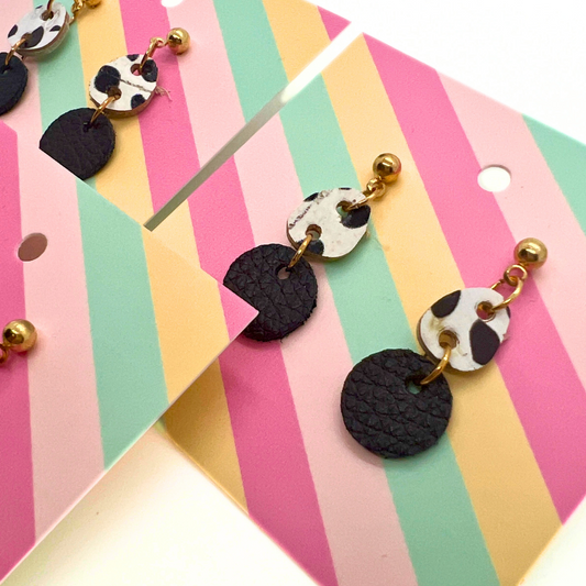 Bold statement earrings in vibrant colors, lightweight and comfortable for all-day wear, handcrafted sustainable leather earrings, eco-friendly jewelry with modern designs, festive holiday earrings perfect for gifting, celestial sun and moon motifs, boho styles with earthy tones, playful Dalmatian print earrings, minimalist earrings styled for the season, bold designs from a small, women-owned business, gift-worthy feather-light earrings, sustainable and recycled leather for eco-conscious fashion