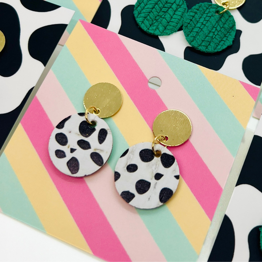 Bold statement earrings in vibrant colors, lightweight and comfortable for all-day wear, handcrafted sustainable leather earrings, eco-friendly jewelry with modern designs, festive holiday earrings perfect for gifting, celestial sun and moon motifs, boho styles with earthy tones, playful Dalmatian print earrings, minimalist earrings styled for the season, bold designs from a small, women-owned business, gift-worthy feather-light earrings, sustainable and recycled leather for eco-conscious fashion