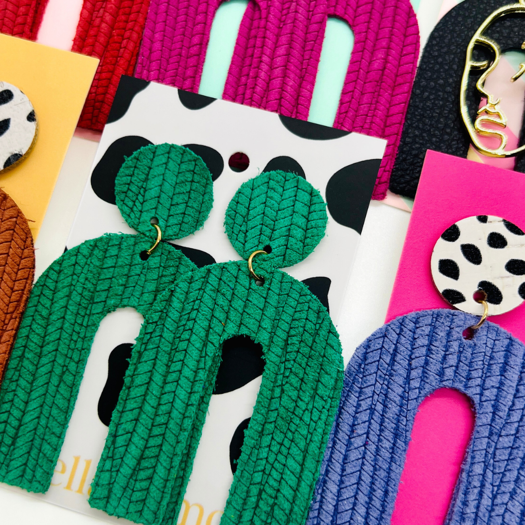Bold statement earrings in vibrant colors, lightweight and comfortable for all-day wear, handcrafted sustainable leather earrings, eco-friendly jewelry with modern designs, festive holiday earrings perfect for gifting, celestial sun and moon motifs, boho styles with earthy tones, playful Dalmatian print earrings, minimalist earrings styled for the season, bold designs from a small, women-owned business, gift-worthy feather-light earrings, sustainable and recycled leather for eco-conscious fashion