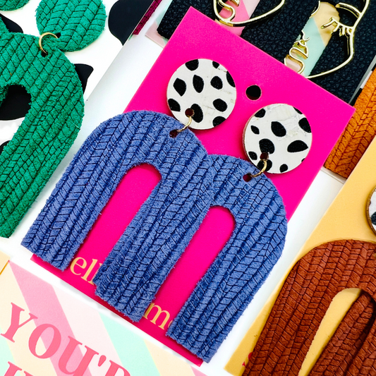 Bold statement earrings in vibrant colors, lightweight and comfortable for all-day wear, handcrafted sustainable leather earrings, eco-friendly jewelry with modern designs, festive holiday earrings perfect for gifting, celestial sun and moon motifs, boho styles with earthy tones, playful Dalmatian print earrings, minimalist earrings styled for the season, bold designs from a small, women-owned business, gift-worthy feather-light earrings, sustainable and recycled leather for eco-conscious fashion