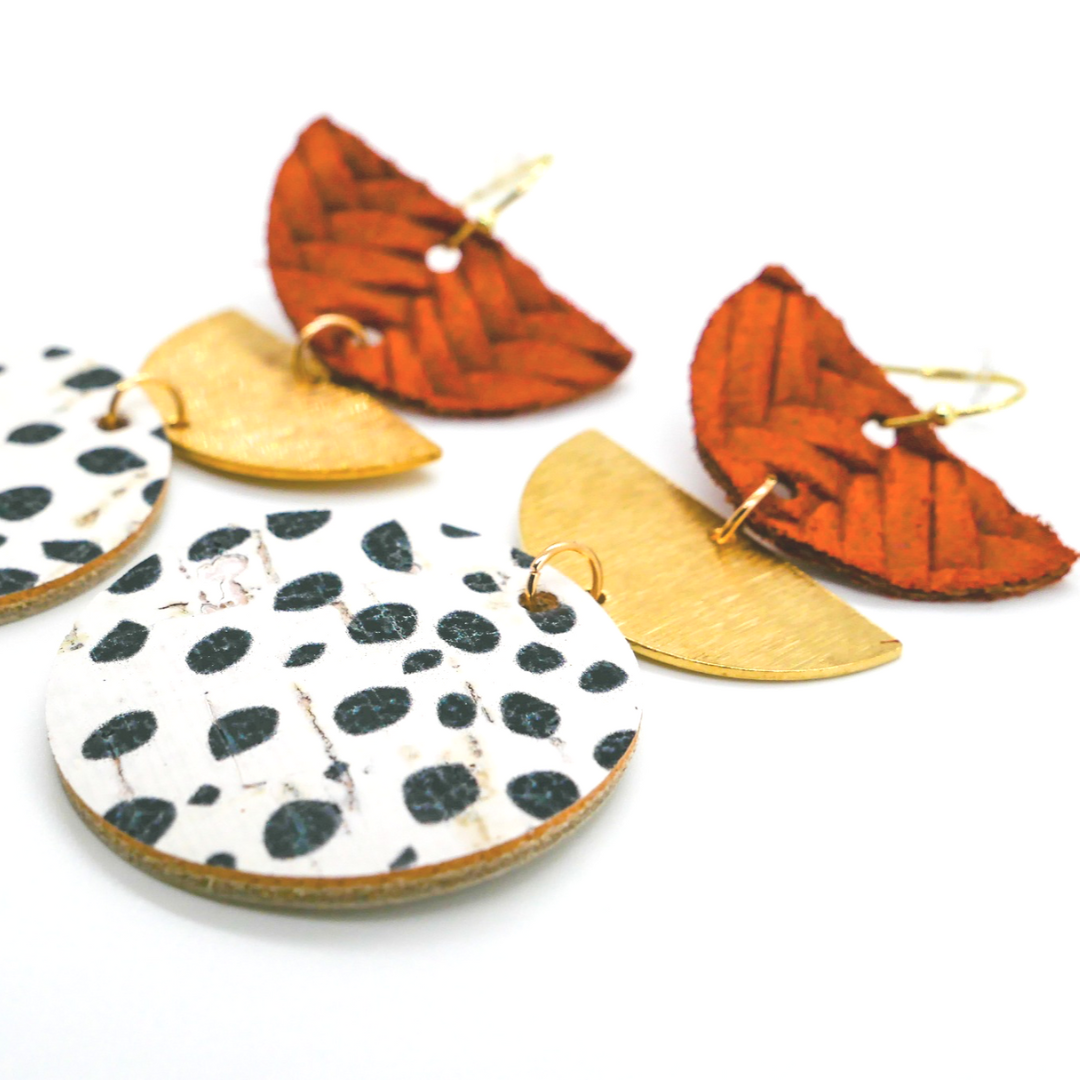 Bold statement earrings in vibrant colors, lightweight and comfortable for all-day wear, handcrafted sustainable leather earrings, eco-friendly jewelry with modern designs, festive holiday earrings perfect for gifting, celestial sun and moon motifs, boho styles with earthy tones, playful Dalmatian print earrings, minimalist earrings styled for the season, bold designs from a small, women-owned business, gift-worthy feather-light earrings, sustainable and recycled leather for eco-conscious fashion