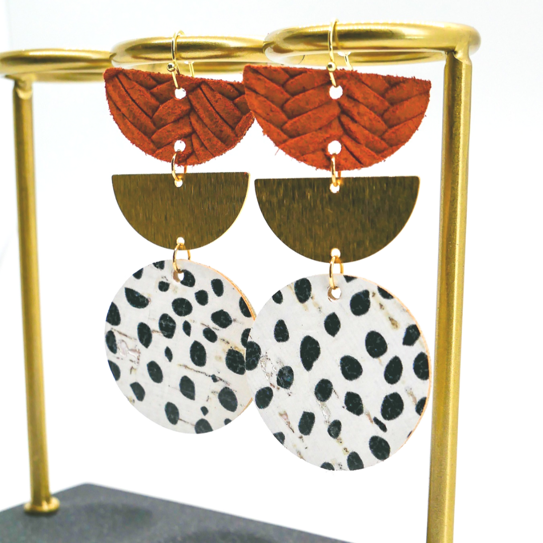 Bold statement earrings in vibrant colors, lightweight and comfortable for all-day wear, handcrafted sustainable leather earrings, eco-friendly jewelry with modern designs, festive holiday earrings perfect for gifting, celestial sun and moon motifs, boho styles with earthy tones, playful Dalmatian print earrings, minimalist earrings styled for the season, bold designs from a small, women-owned business, gift-worthy feather-light earrings, sustainable and recycled leather for eco-conscious fashion