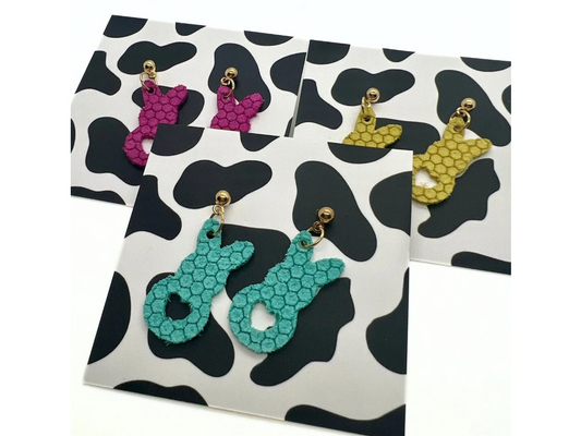 Bold statement earrings in vibrant colors, lightweight and comfortable for all-day wear, handcrafted sustainable leather earrings, eco-friendly jewelry with modern designs, festive holiday earrings perfect for gifting, celestial sun and moon motifs, boho styles with earthy tones, playful Dalmatian print earrings, minimalist earrings styled for the season, bold designs from a small, women-owned business, gift-worthy feather-light earrings, sustainable and recycled leather for eco-conscious fashion